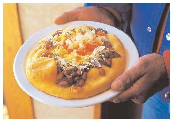 The frybread taco is a relatively recent addition to Native American fare. It requires white wheat flour, which came to the New World with Europeans. [Photograph by Catherine Karnow. Corbis. Reproduced by permission.]